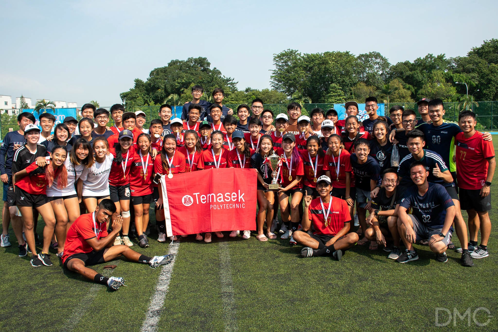 Image of a group of student-athletes taking a team shot after a competition